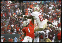 FSU & UM football players battle for the ball. 
