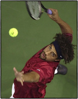 Mardy Fish serves tennis ball. 