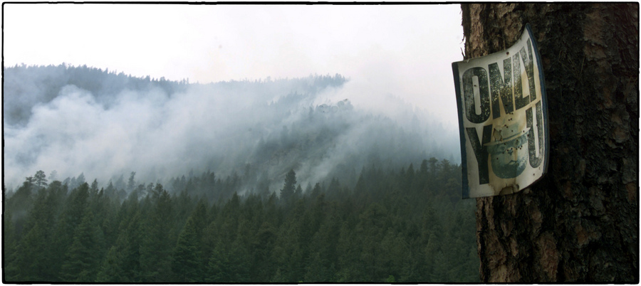 A sign hangs on a tree as a wildfire continues to burn, New Mexico. : Aftermath sessions : Oklahoma City Editorial and Documentary Photographer 