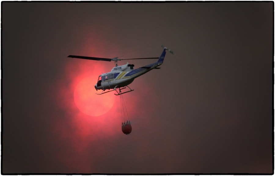A helicopter carries water to a Wyoming wildfire. : Aftermath sessions : Oklahoma City Editorial and Documentary Photographer 