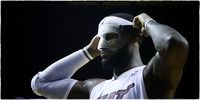 Miami Heat's LeBron James adjust face mask.