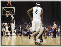 LeBron James holds his son during an exhibition game