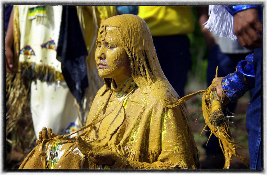 The girl is covered with a mixture of clay and corn meal that cannot be washed off during the ceremony. This is test of mental strength.  : The First Americans : Oklahoma City Editorial and Documentary Photographer 