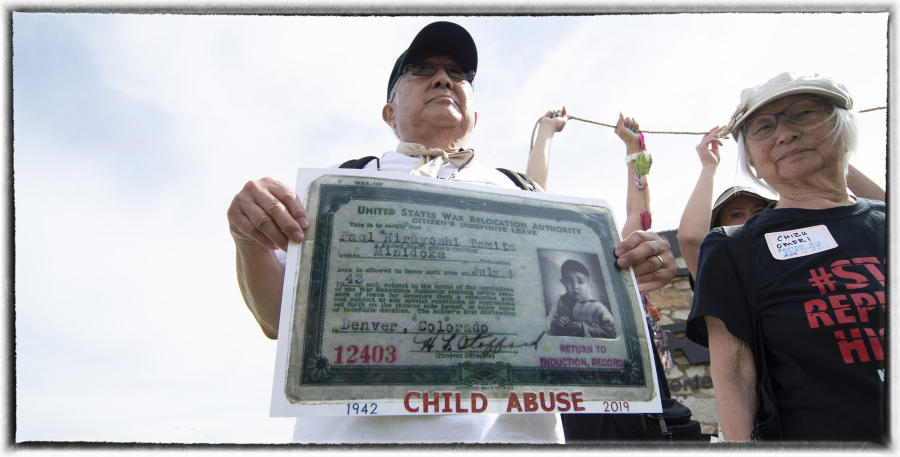 Paul Tomita, holding his camp ID card, protests the government plans to house 1,400 children without their parents at the Army base.  : Immigrants - An American Story : Oklahoma City Editorial and Documentary Photographer 