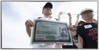 Paul Tomita, holding his camp ID card, protests the government plans to house 1,400 children without their parents at the Army base. 