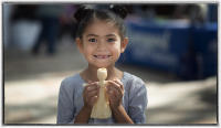 Young girl with traditional Native American corn husk doll